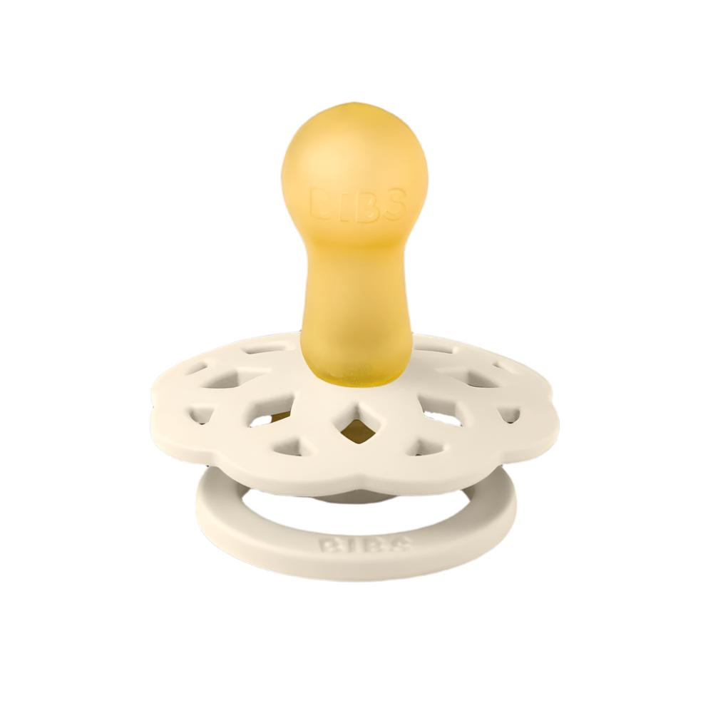 Pacifier with yellow nipple and white round floral shield, with gold center ring