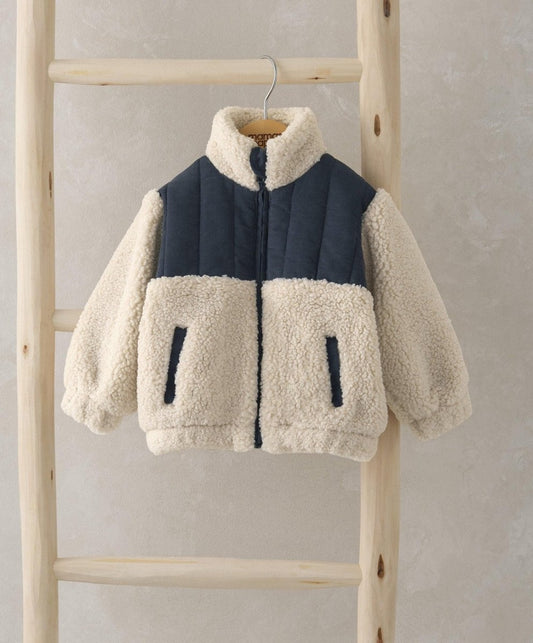 Borg jacket with beige sherpa sleeves and black front panel, zip-up with patch pockets