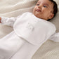 White baby bib worn by baby, with “Born 2025” embroidery on the front