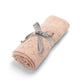 Pink pointelle baby blanket, folded with light gray bow tie