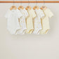 Baby sleepsuit set of 5, pale yellow and white with small botanical prints, short sleeve