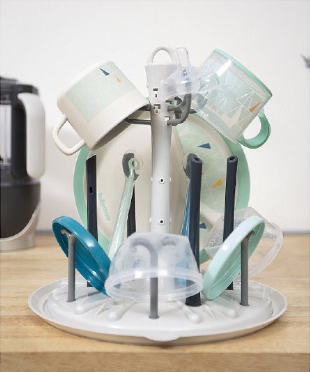 Bottle dryer with rotating arms holding clear cups and bottle inserts
