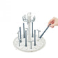 Bottle dryer rack with upright white frame, blue rods, and bottle slots on base