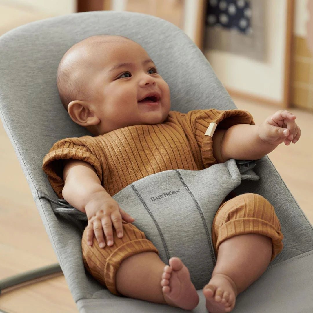 Light grey baby bouncer chair with curved seat and cushioned 3D jersey cover