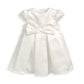 White bow dress with short puff sleeves, gathered waist and pleated skirt