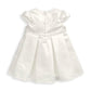 White bow dress with structured bodice, puff sleeves and pleated skirt