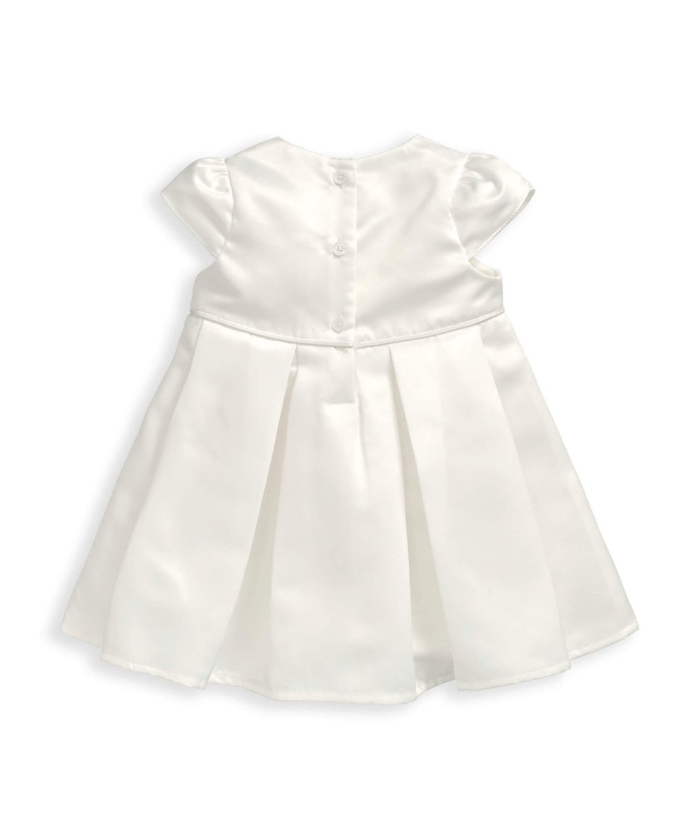White bow dress with structured bodice, puff sleeves and pleated skirt