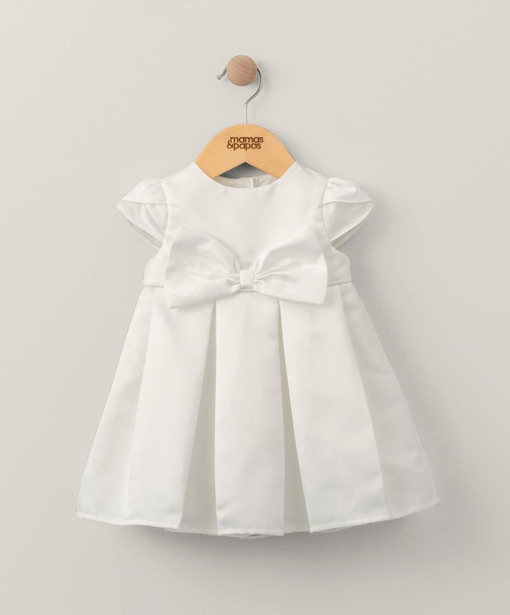 White bow dress with cap sleeves and waist tie, pleated skirt