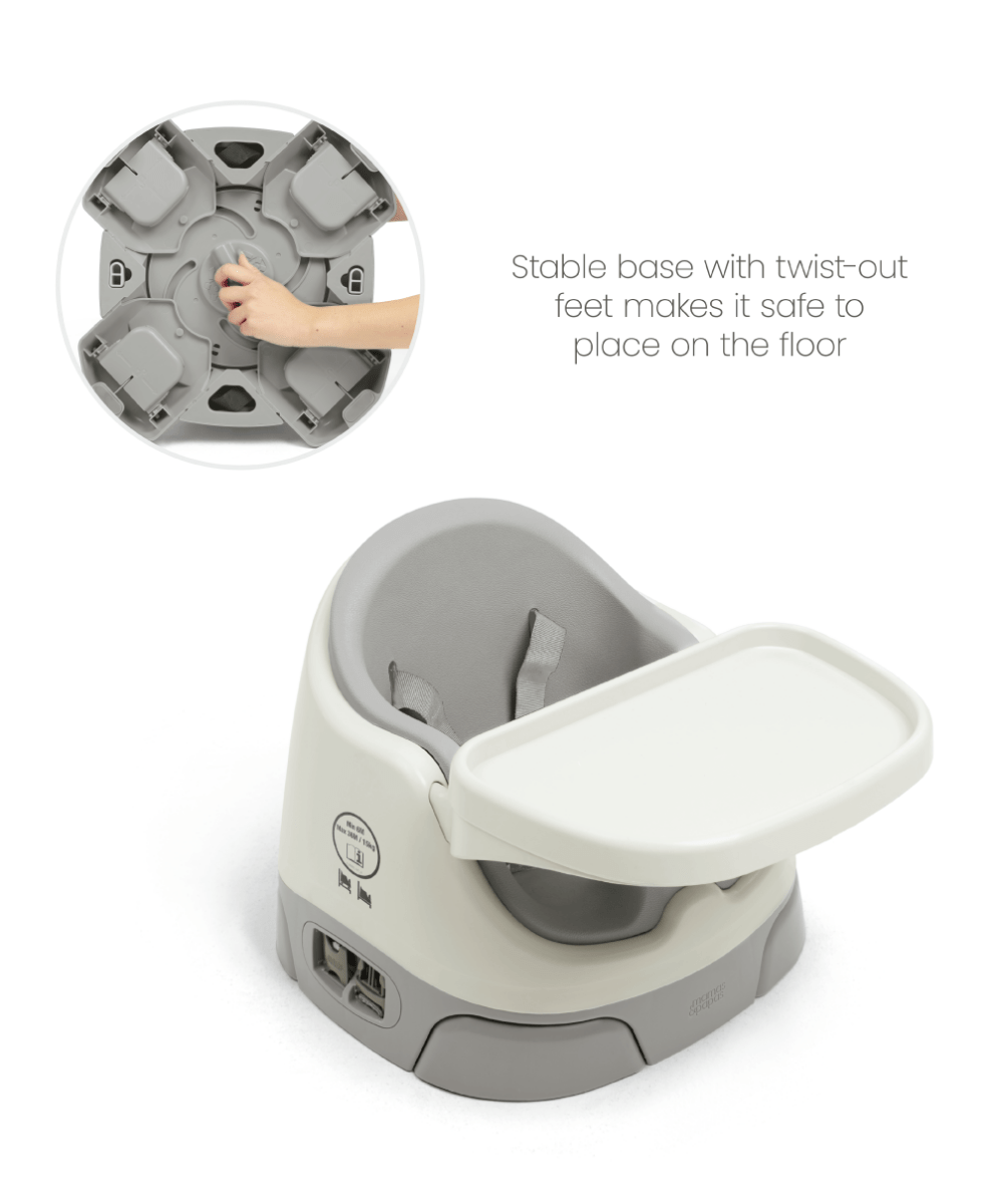 Baby booster seat with activity tray, dark gray and white, angled view
