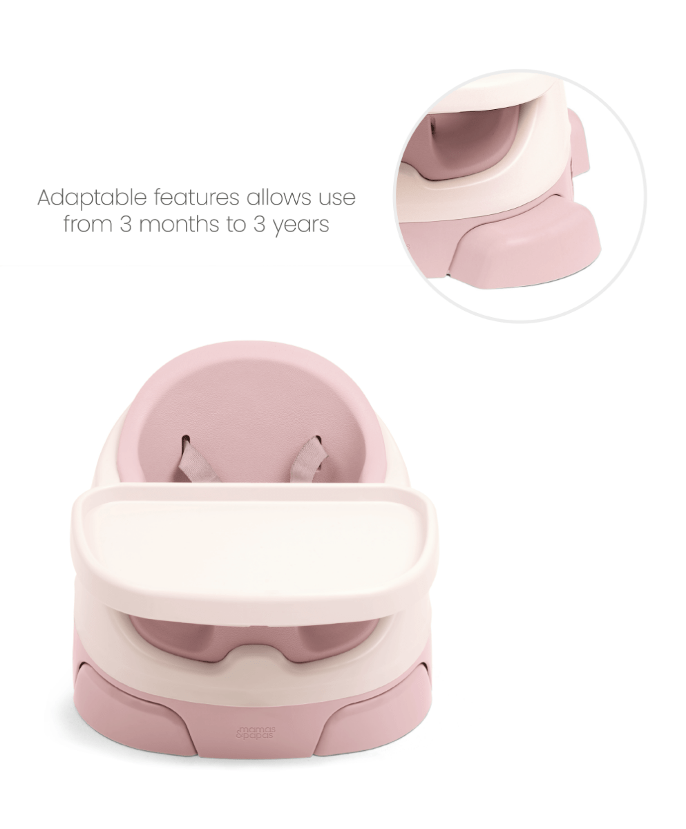 Baby booster seat with activity tray, blush pink seat and white tray, close-up angle
