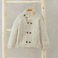 Cream cable knit cardigan with stand collar, double-breasted buttons and textured knit