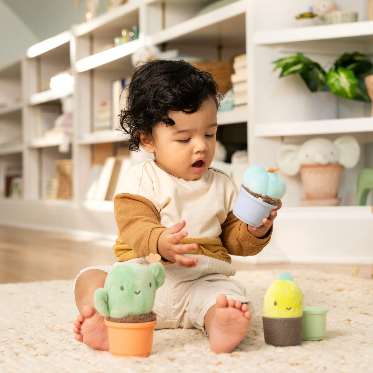 Plush cactus nesting rattle cup with smiling face, plus green and yellow pieces