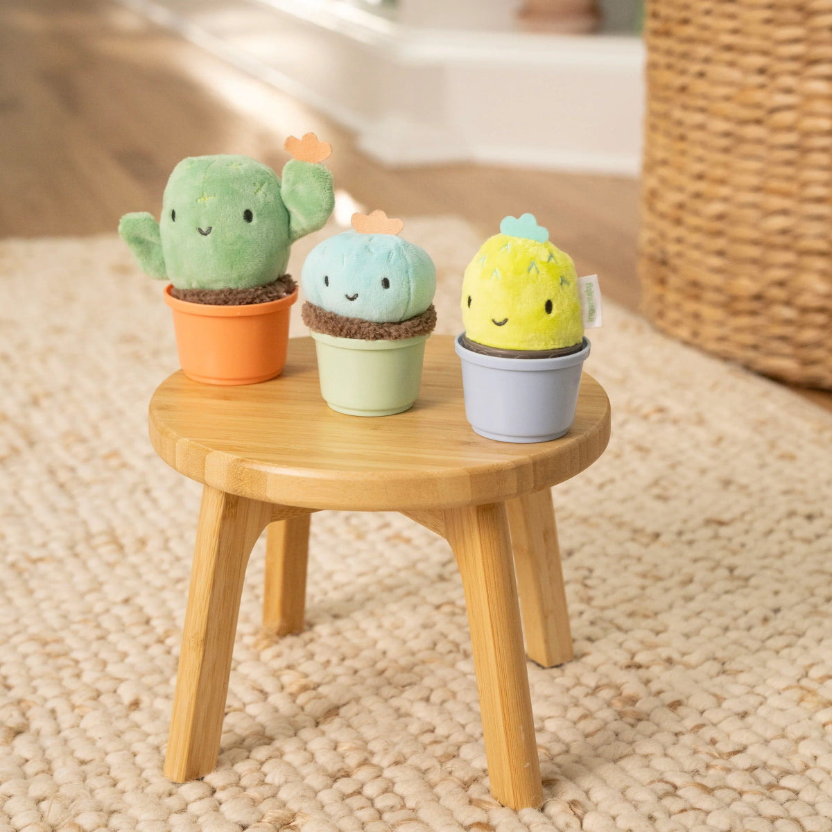 Plush cactus nesting rattle set with green, light blue, and yellow cups