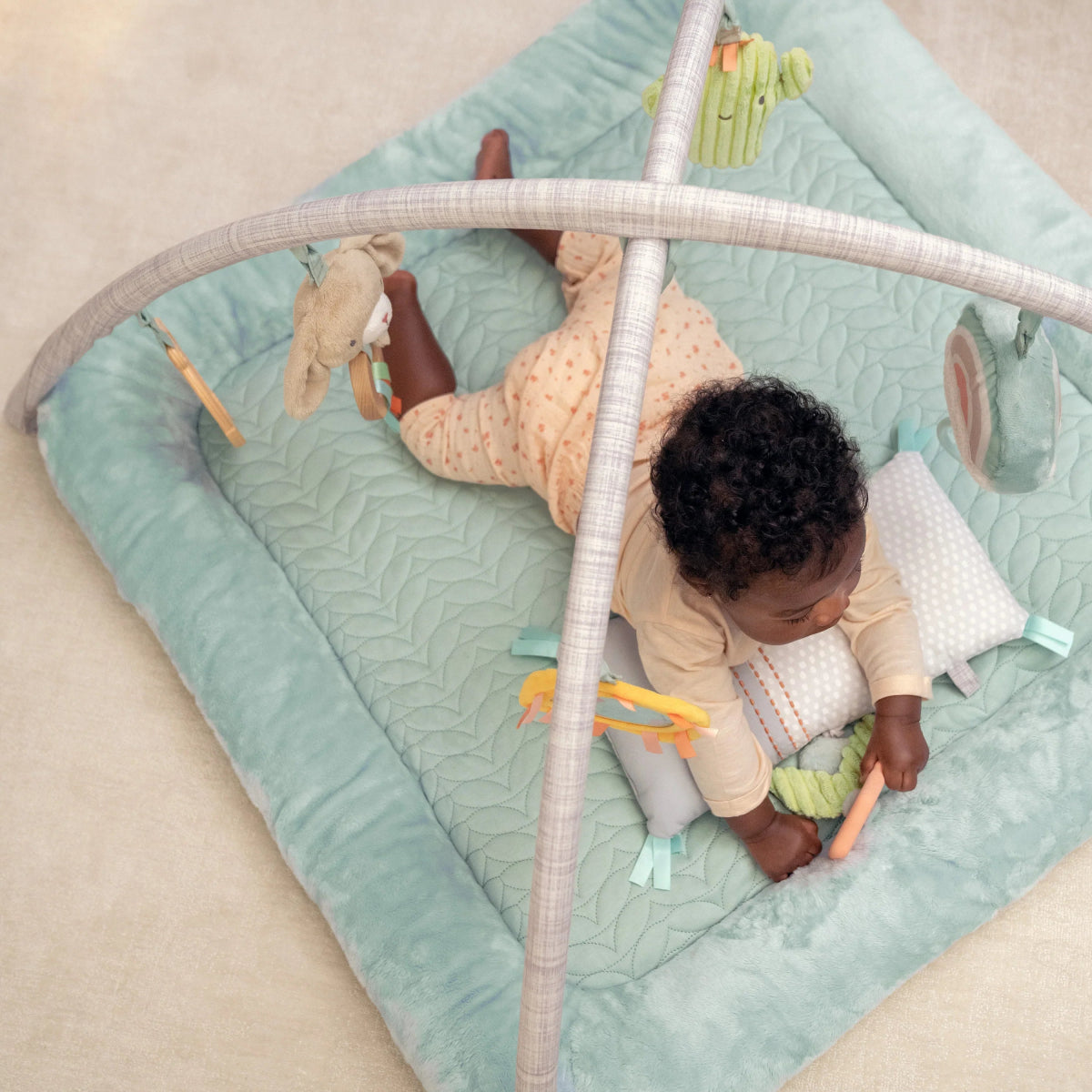 Plush baby activity gym with quilted padded mat and hanging fabric activity toys