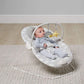 Bouncing cradle with gray-and-white seat, infant, star toy overhead