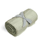 Cellular blanket in sage green, rolled bundle tied with fabric bow