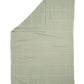 Cellular blanket in sage green, neatly folded with textured pattern