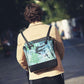 Changing bag worn crossbody, black with green tropical leaf print and side zip pocket