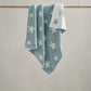 Chenille blanket in light blue with white star pattern, draped with folded corners