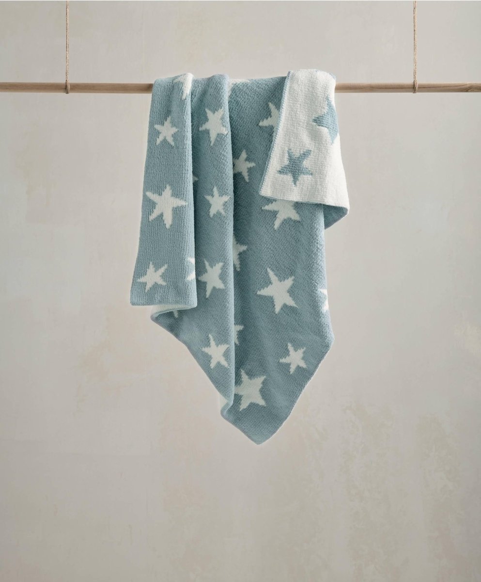 Chenille blanket in light blue with white star pattern, draped with folded corners