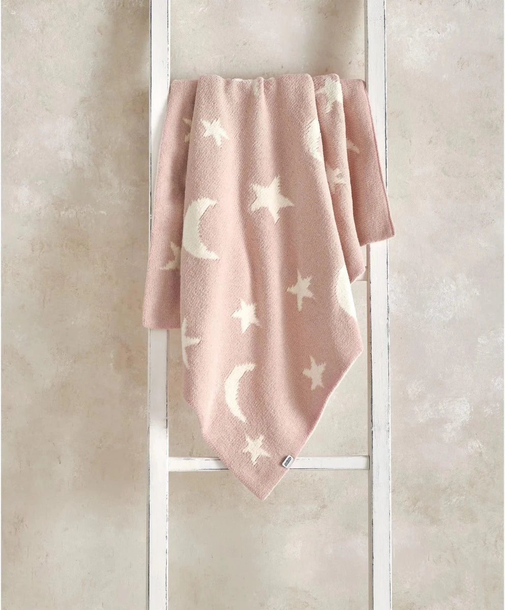 Pink chenille blanket with white stars and crescent moons, draped front