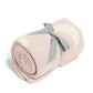 Pink chenille blanket roll-up with white stars and moons, tied with gray ribbon
