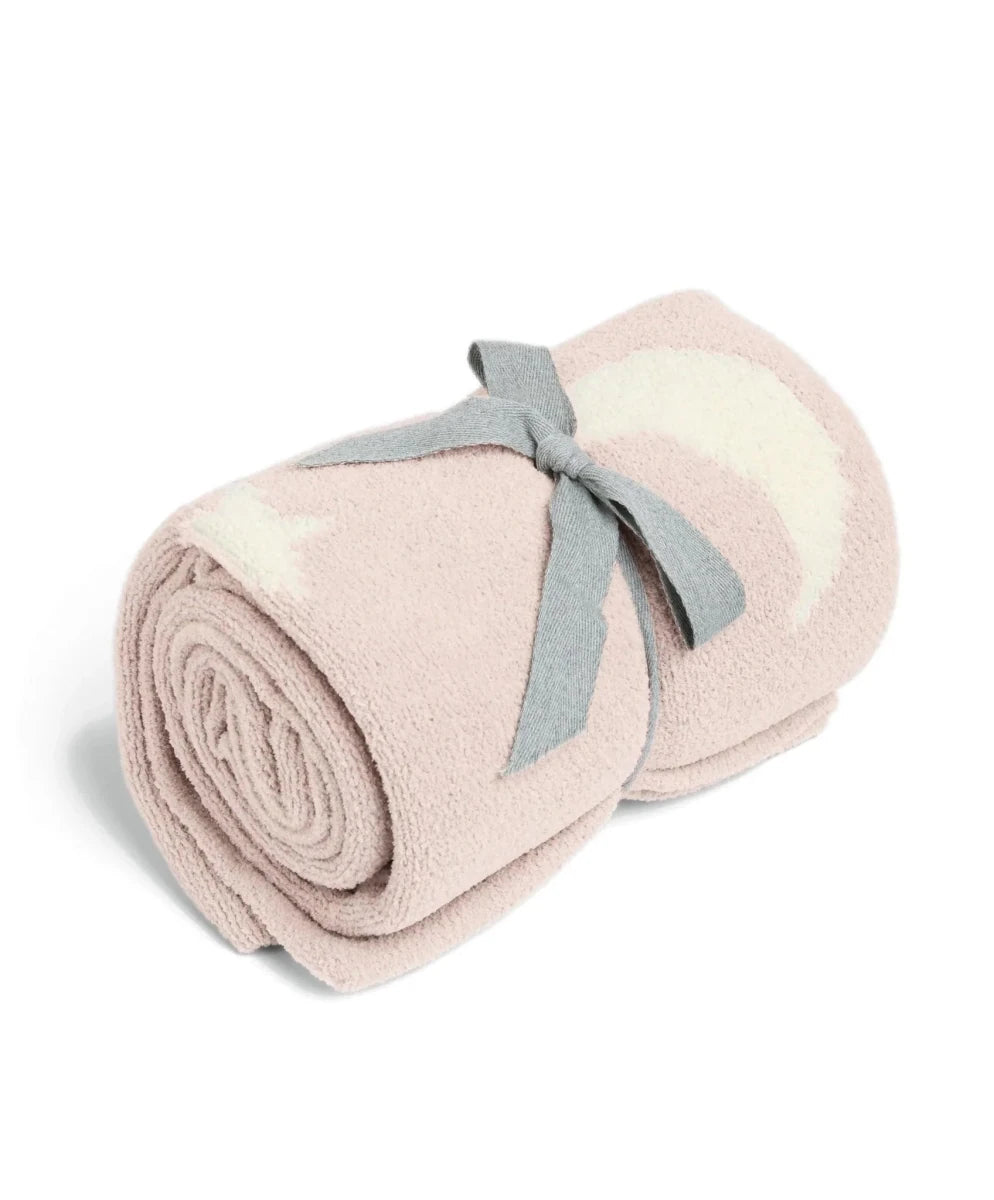 Pink chenille blanket roll-up with white stars and moons, tied with gray ribbon