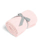 Pink chenille blanket, folded with a gray ribbon tag