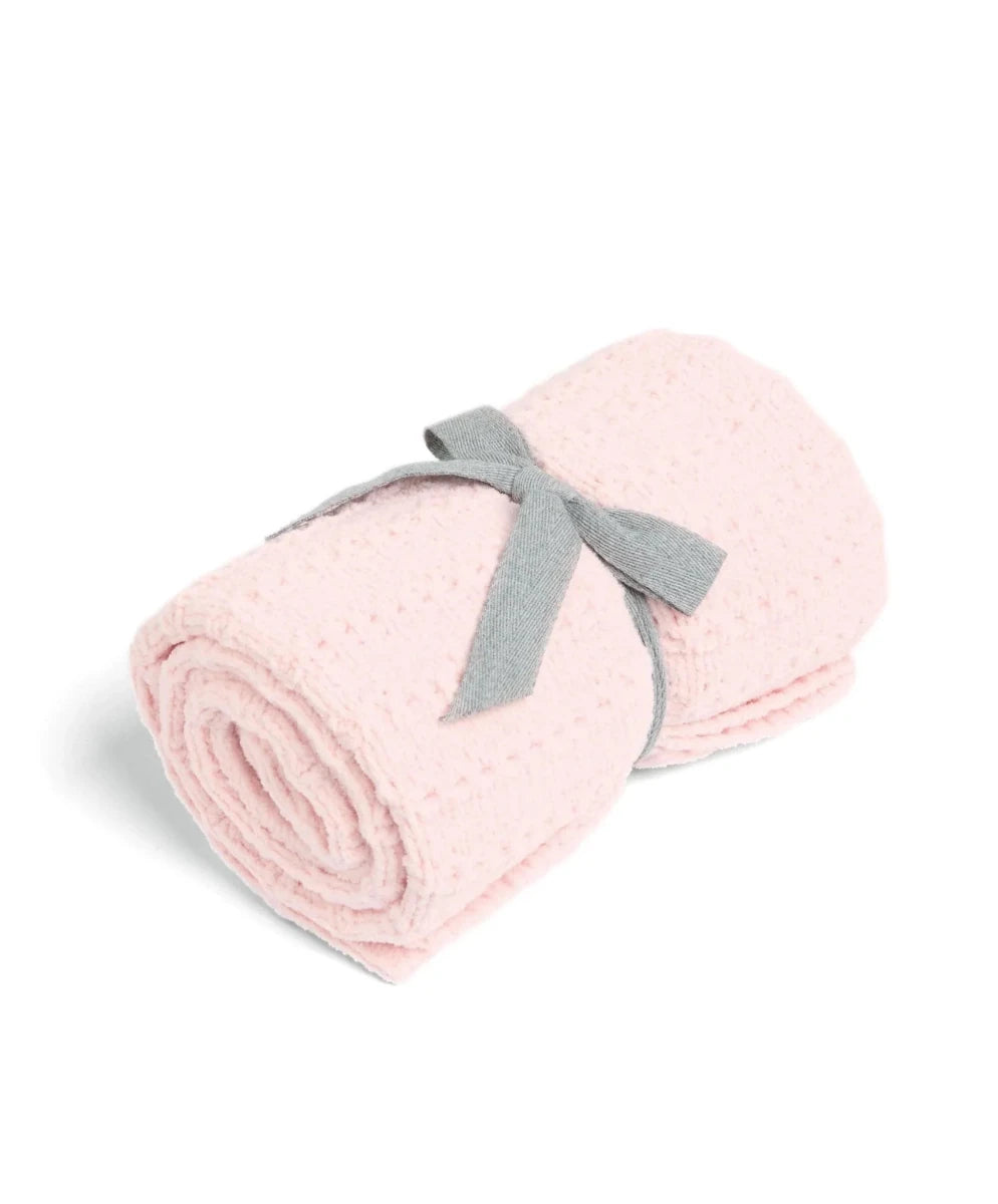 Pink chenille blanket, folded with a gray ribbon tag