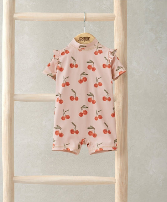 Kids cherry all-over print rash guard suit, pale pink with red cherries, short sleeves