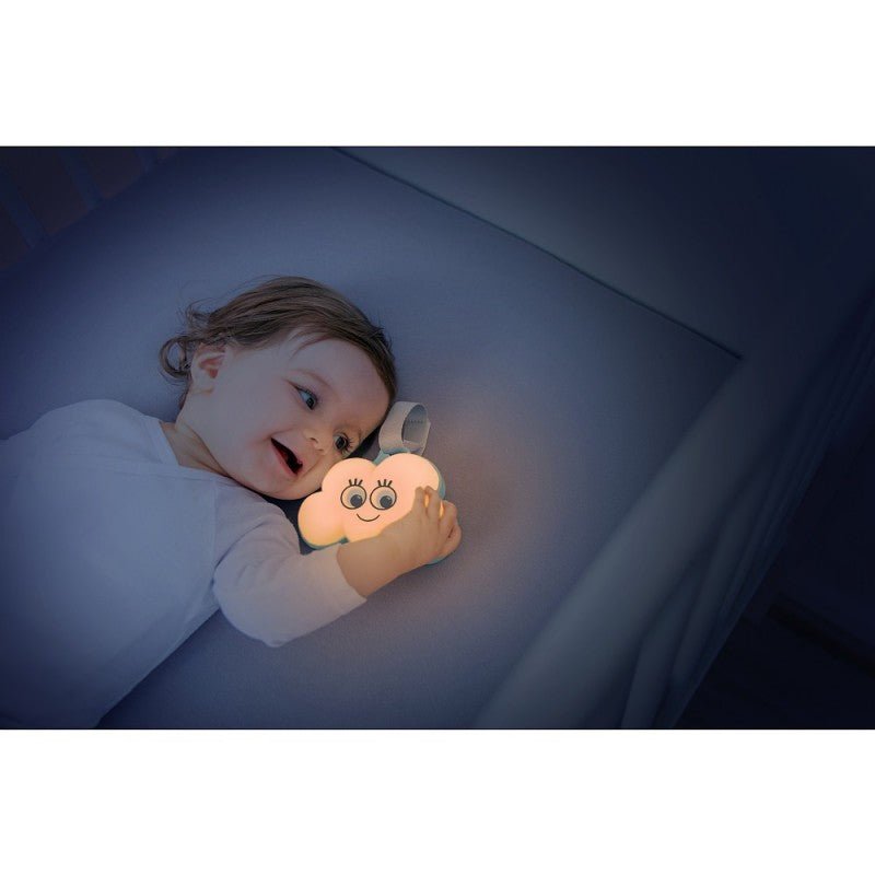 Glowing cloud-shaped baby night light held by a child at bedtime
