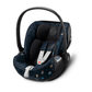 Rear-facing baby car seat with dark blue patterned interior, black shell, side handle