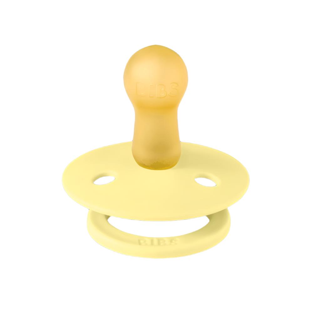 Yellow silicone pacifier with round shield and ventilation holes