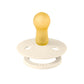 Ivory baby pacifier with round shield and yellow nipple