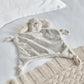 Light grey bunny comforter with plush ears and floppy arms, soft velvety fabric.