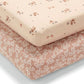 Cotbed fitted sheet, pale pink with small floral and bird pattern; elastic corners