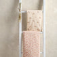 Cotbed fitted sheet set on cot rails, pale floral and blush floral fitted sheets