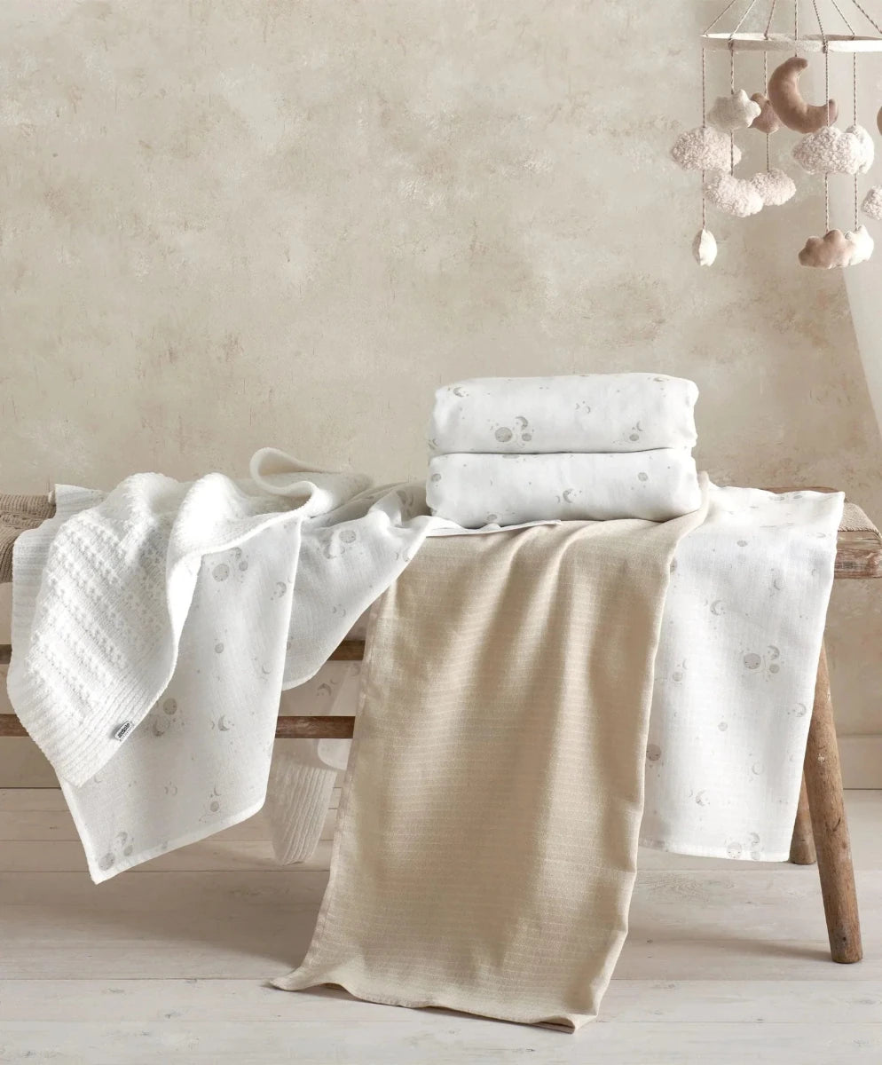 Cotbed fitted sheets (2-pack) in white with small space prints, folded on cot