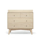 Nursery dresser changer front view in natural wood with four drawer fronts and legs