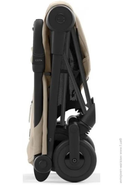 Beige compact stroller in folded position, side angle with visible wheels