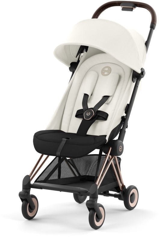 Ultra-compact stroller with white canopy and black seat, rose-gold frame, side view
