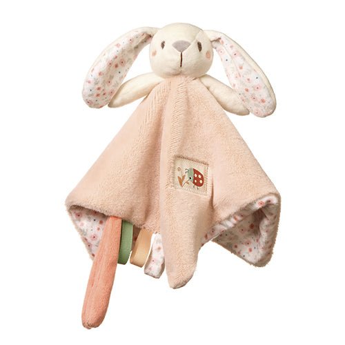 Plush bunny toy with beige dress, speckled paws, and small character patch on chest.