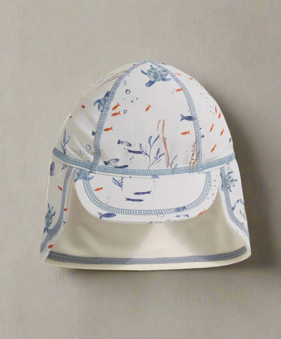 White swim hat with blue sea animal print and chin strap