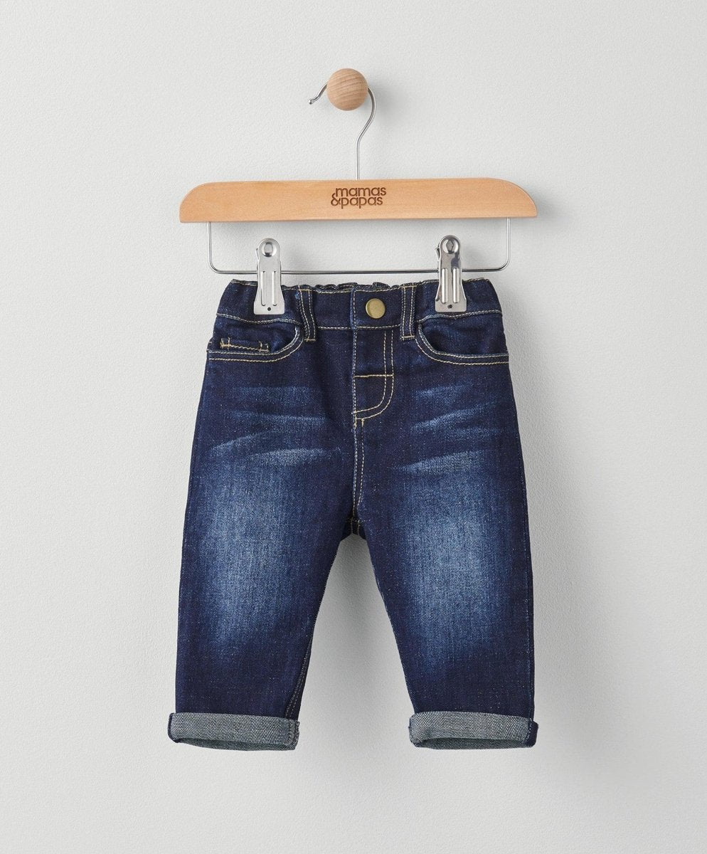 Dark blue denim jeans with cuffed hems, belt loops, and contrast stitching