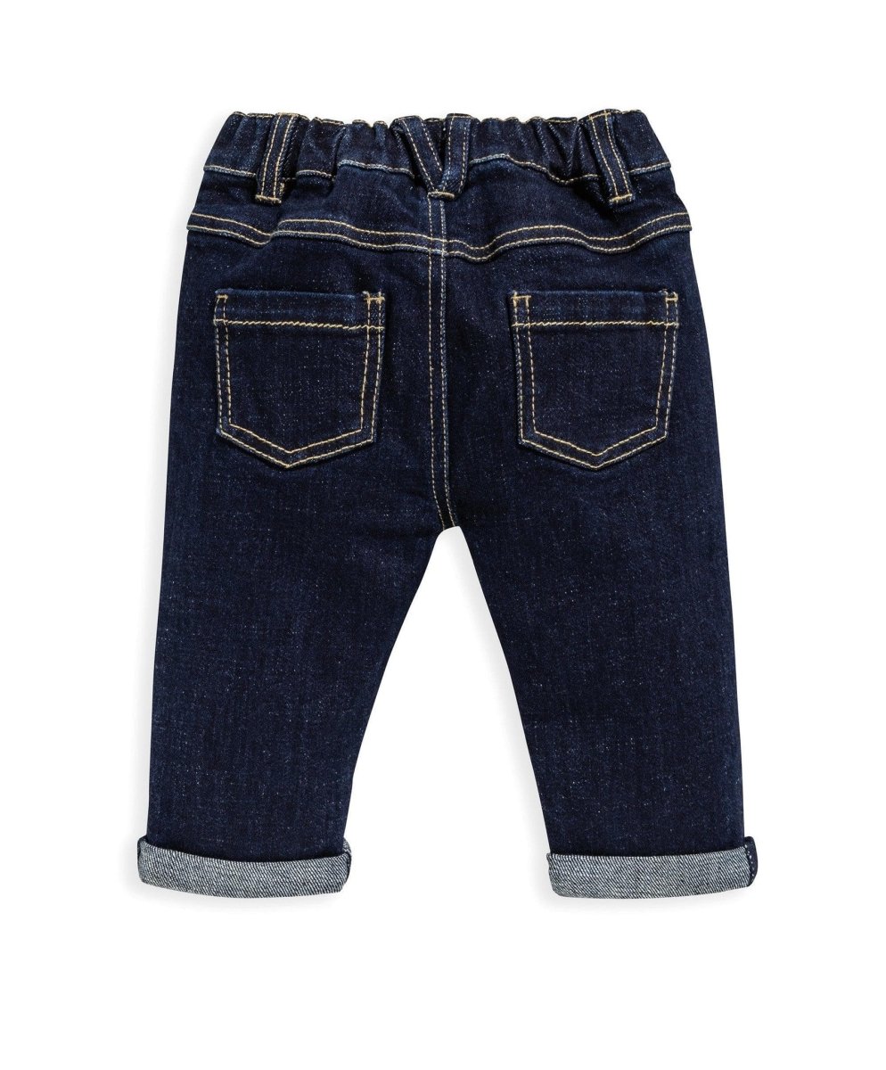 Dark denim jeans with two back pockets, stitched seams, and cuffed legs