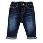 Navy denim jeans with front button, belt loops, and rolled cuffs