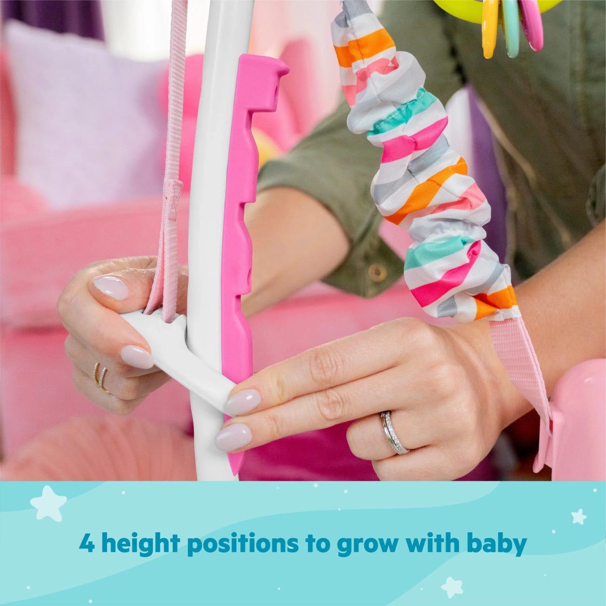 Pink baby activity jumper height-adjustment lever near padded side frame