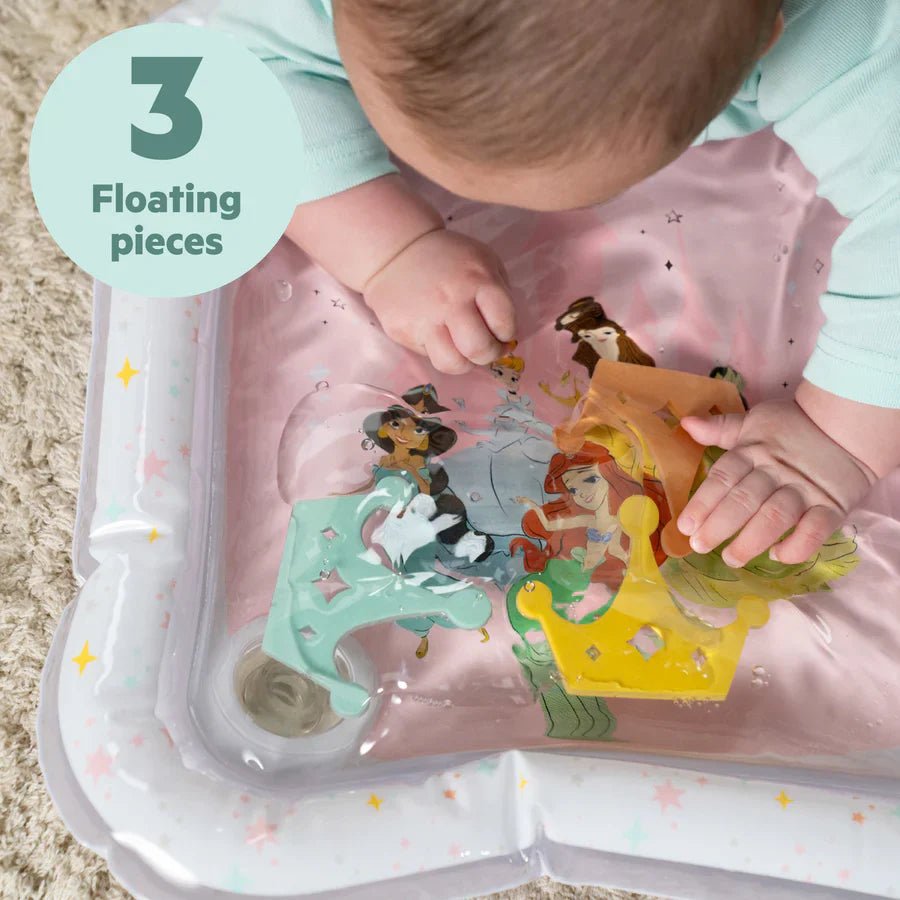 Inflatable water play mat with princess-themed floating pieces, close-up on hands
