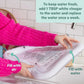 Inflatable water play mat with clear inner surface and valve, being filled