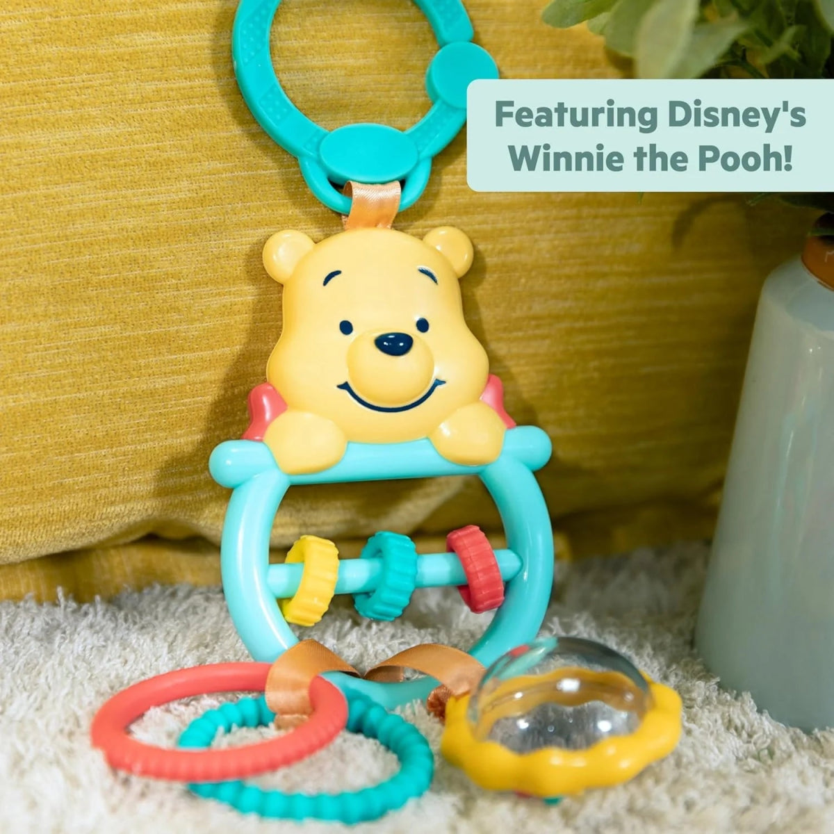 Winnie the Pooh activity toy with teal frame, front Pooh face, and colorful blocks